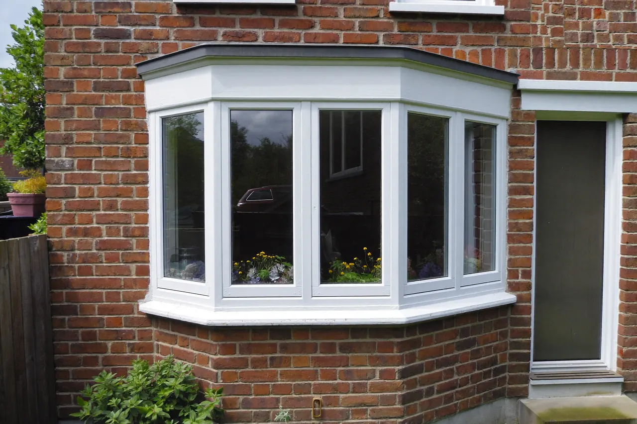 A splayed bay window on the front of a brick house