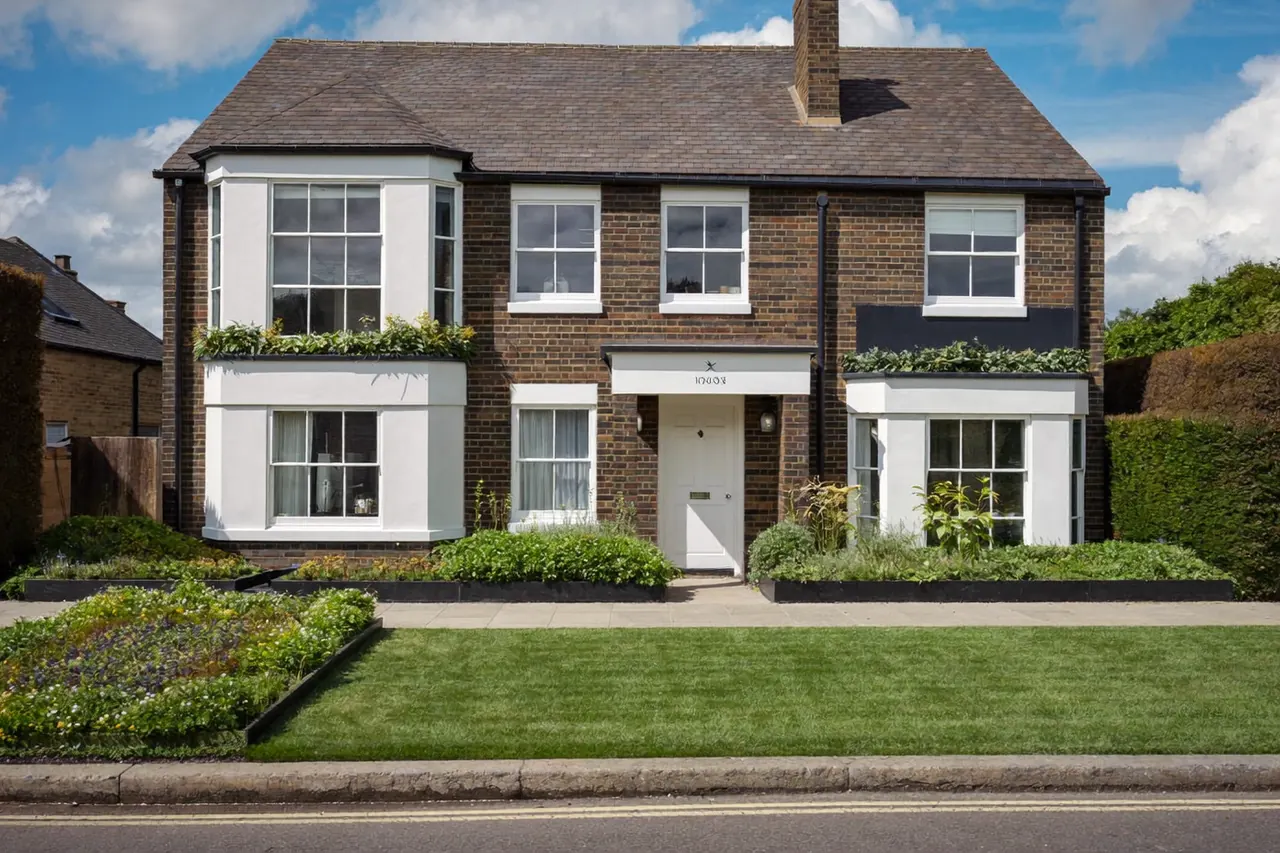 A house exterior with a consistent set of new white-framed windows