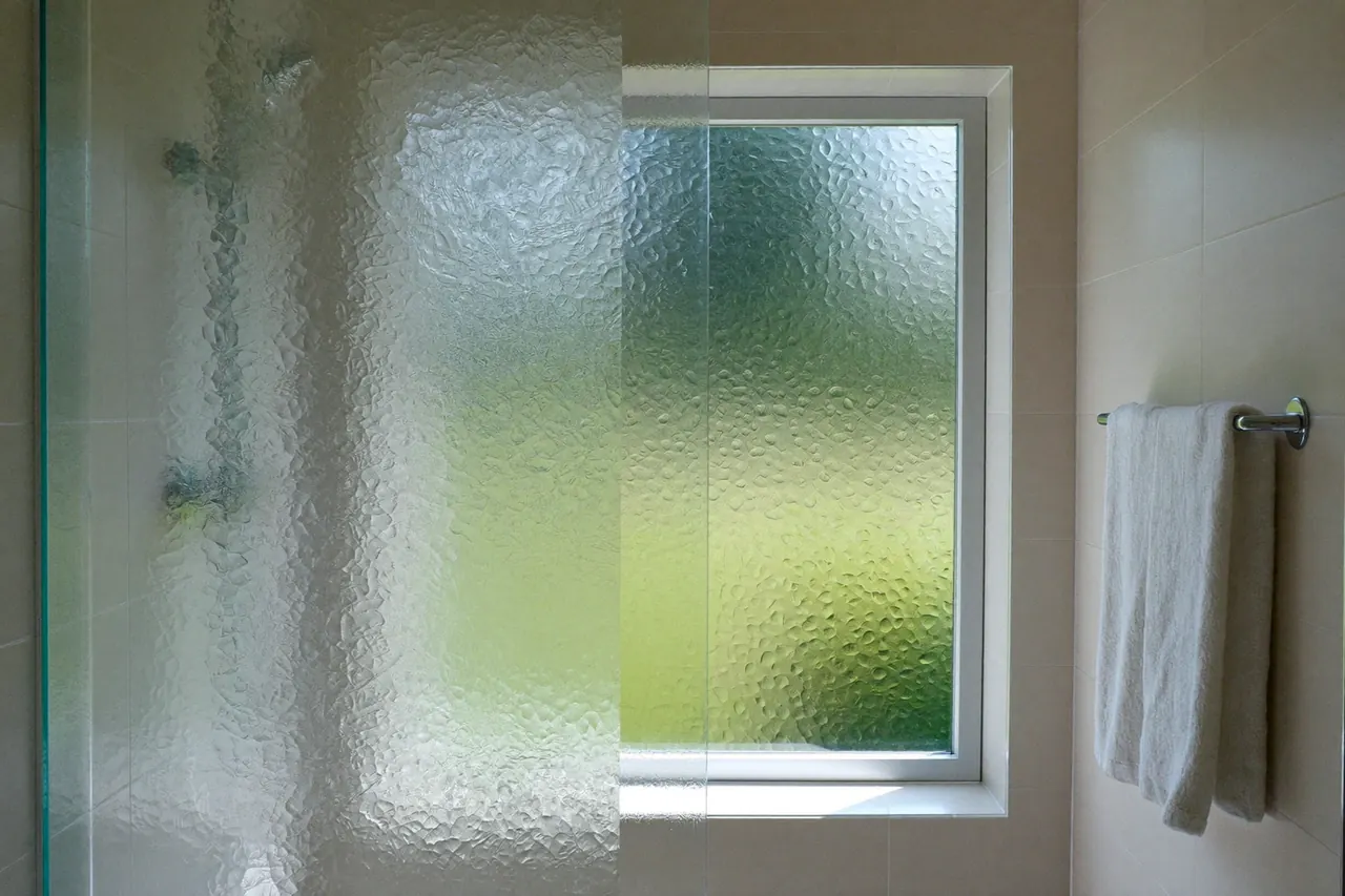 A bathroom window fitted with obscured privacy glass