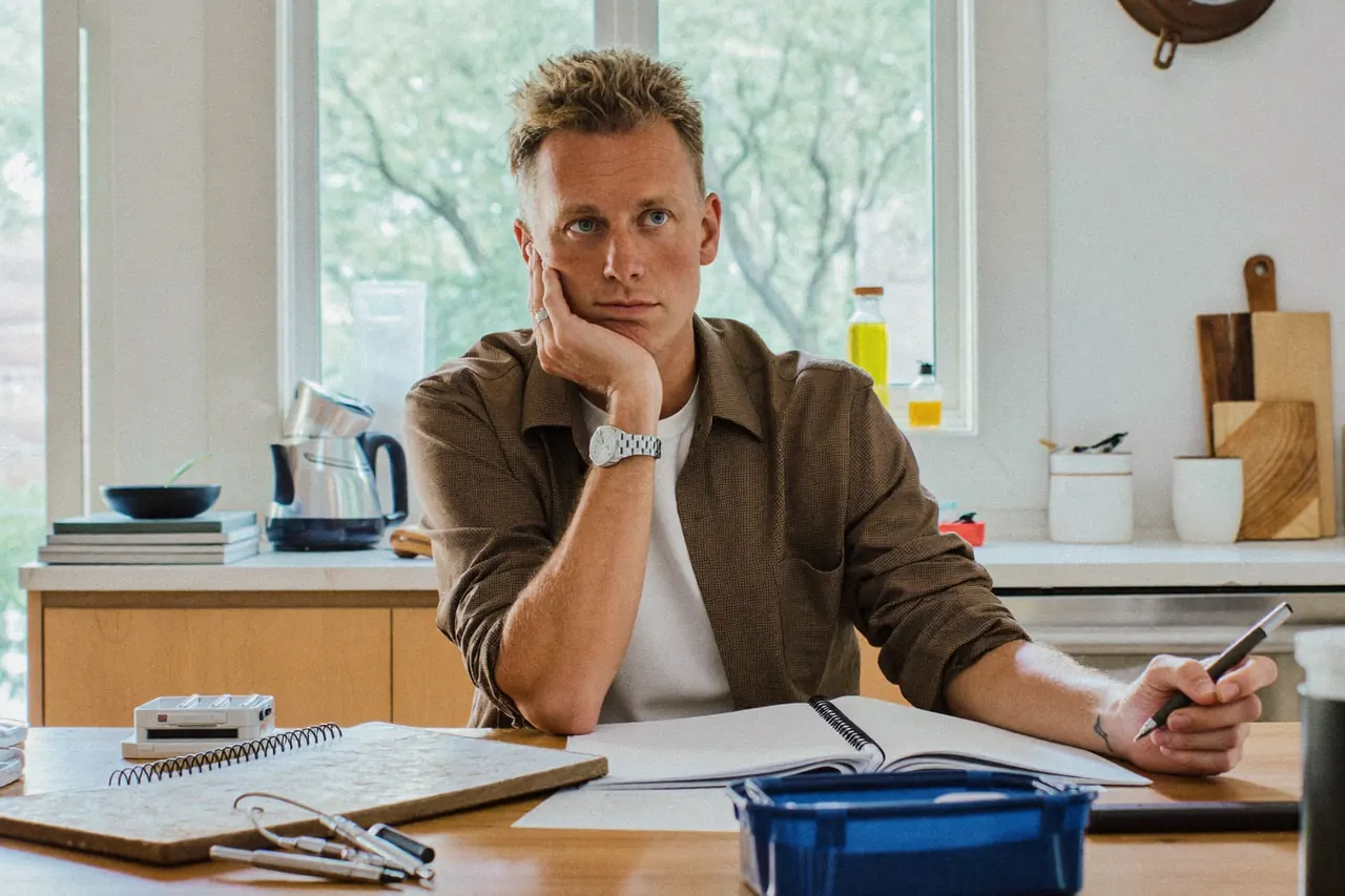 Homeowner planning a window replacement project at a kitchen table