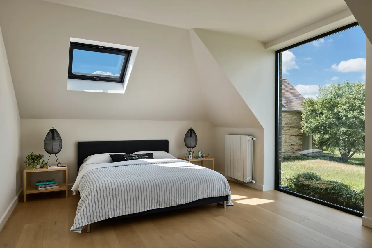 A loft room lit by a roof window set into the ceiling slope