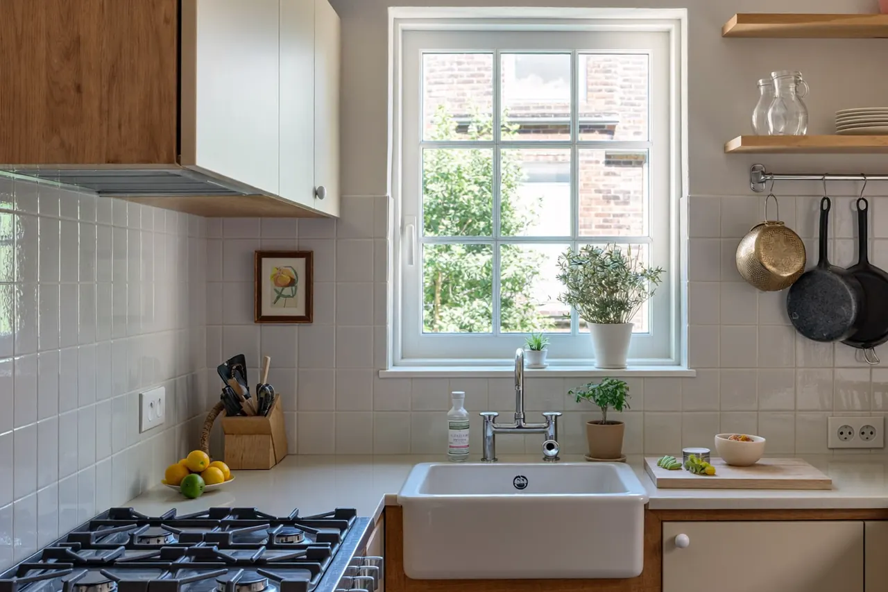 A modern kitchen with a new window above the sink letting in natural light