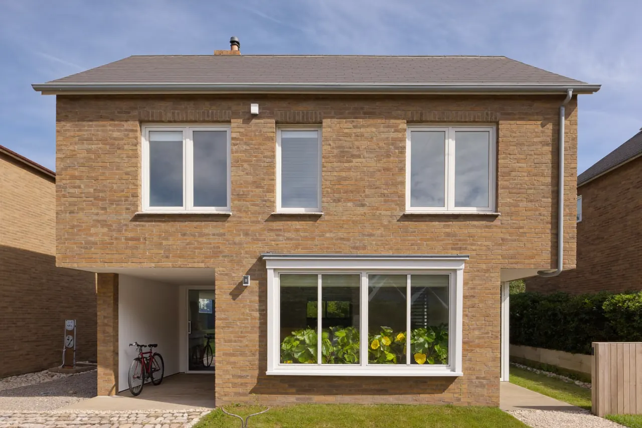 A semi-detached house with newly replaced windows across both floors