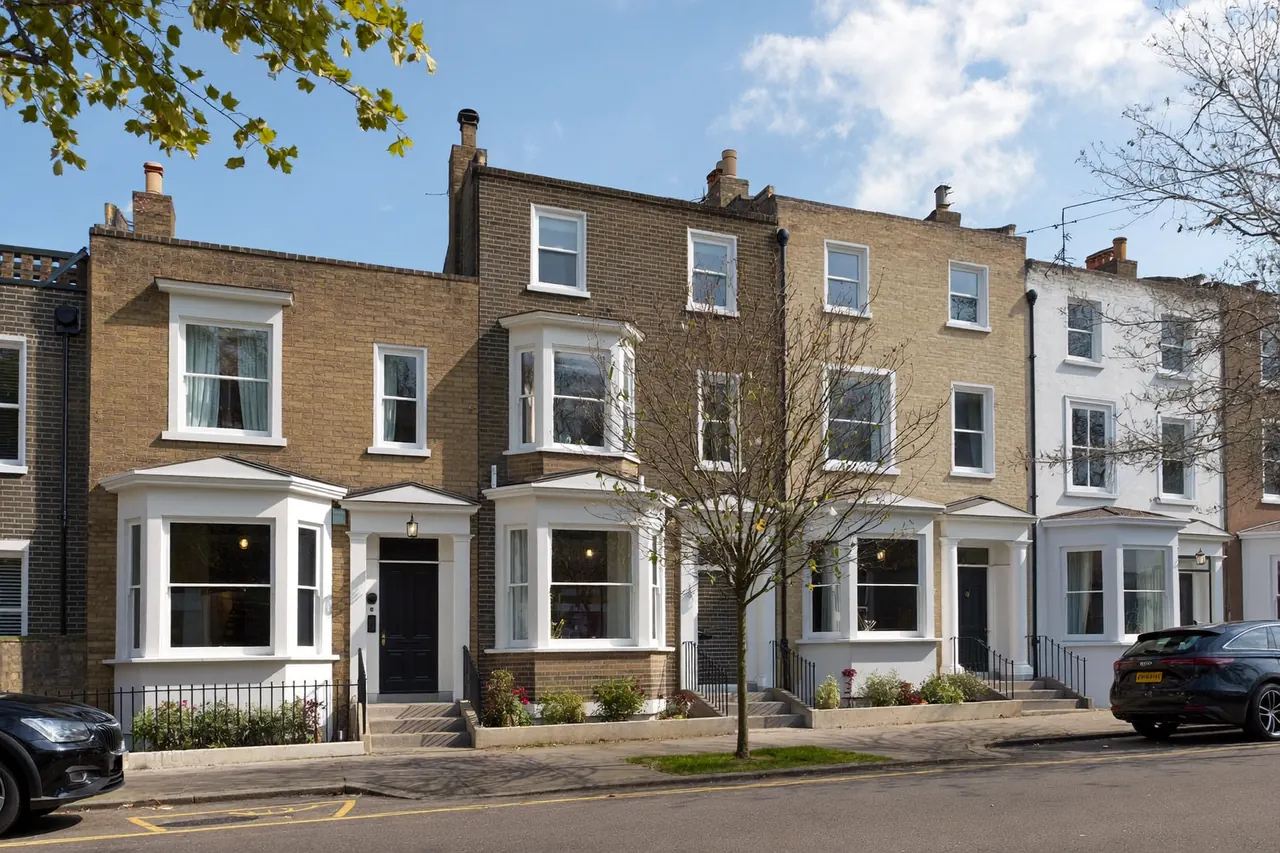 A row of terraced houses with a mix of window styles